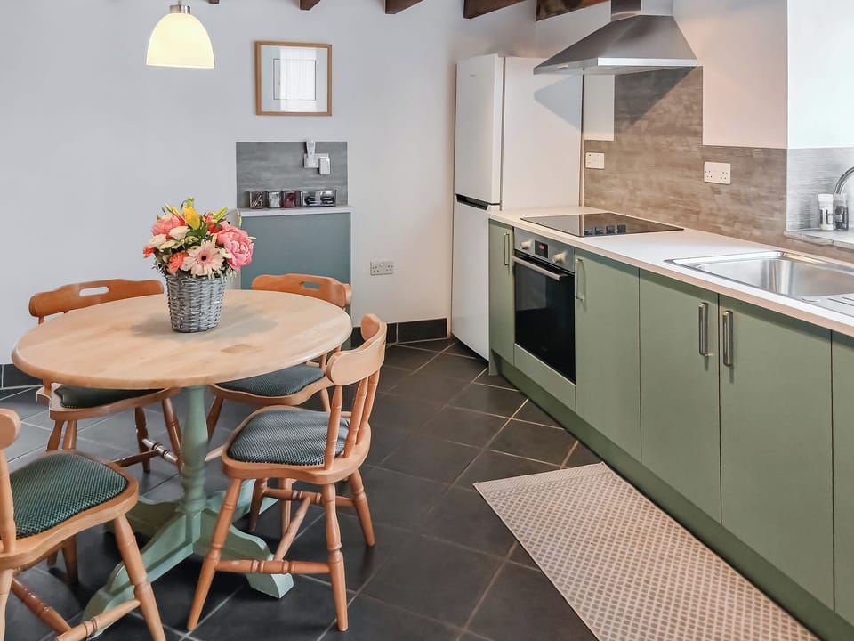 Kitchen/ dining room with beamed ceiling and slate floor | Beckaveans Granary - Beckaveans, Jacobstow, near Bude