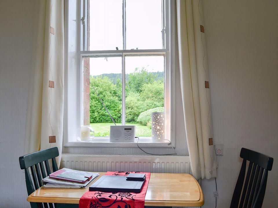 Compact dining area with wonderful view over the garden to the fells beyond | Ticket Office - Torver Station Cottages, Torver, near Coniston