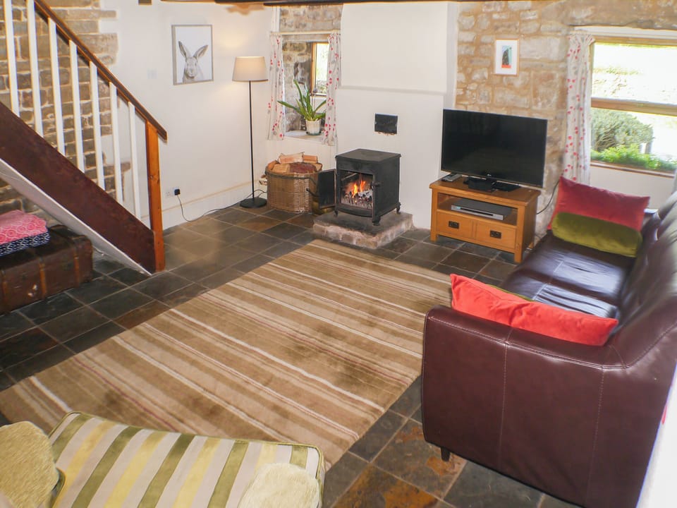 Comfortable and cosy flag-floored living room | Garden Cottage, Onecote, near Leek