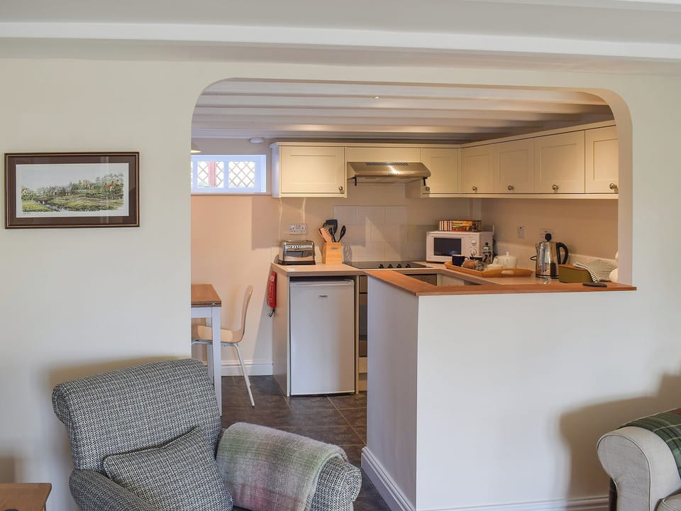 Delightful kitchen/dining area separated by an archway from the living room | Rowan Cottage, Aislaby, near Whitby