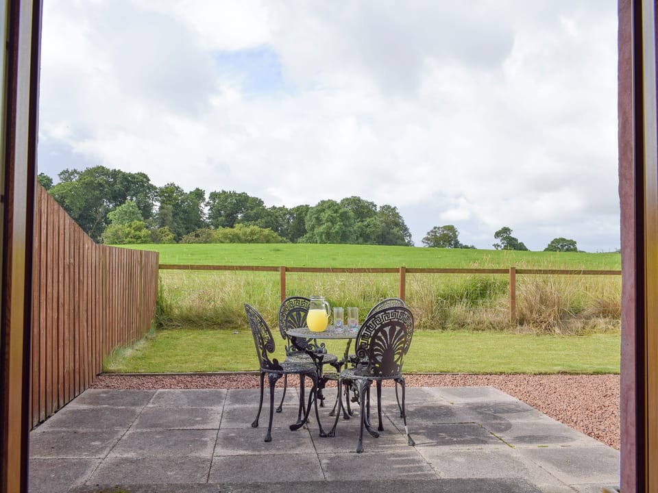 Double doors from kitchen leading to rear patio and garden | The Ploughmans - Loch Lomond Farm Cottages, Balfron Station, near Stirling