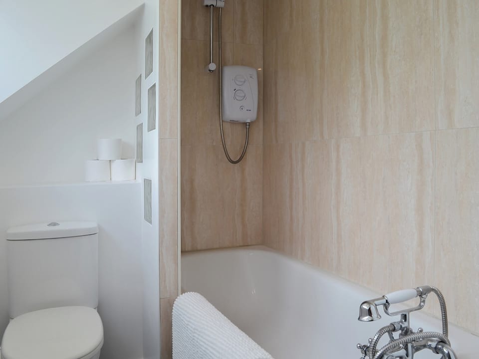 Bathroom with shower over the bath | Rhos Y Grug, Llangwnadl, near Pwllheli