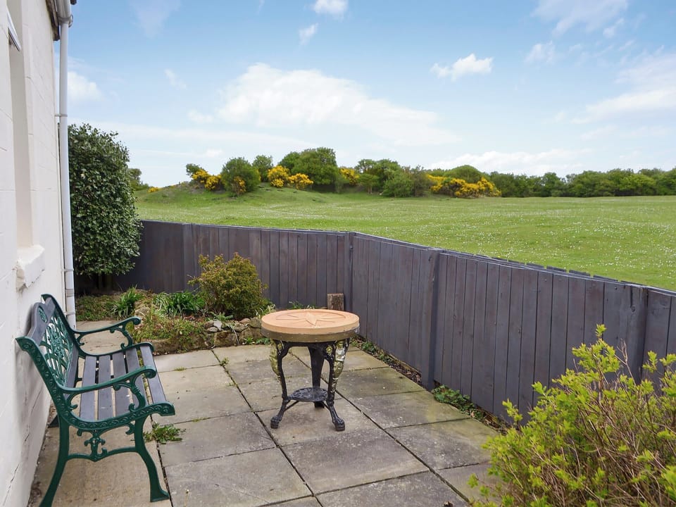 Enclosed garden with sitting-out area and garden furniture | Brier Dene End Cottage - Brier Dene Farm Cottages, Old Hartley, near Whitley Bay 