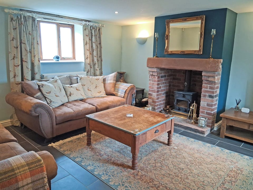 Cosy living room with wood burner | Swallow Barn, Torpenhow, near Wigton