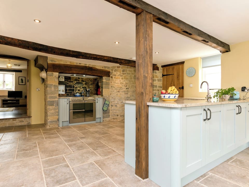 Well-equipped, beamed kitchen/dining room with electric range (for cooking) | The Farmhouse at Higher Westwater Farm, Axminster