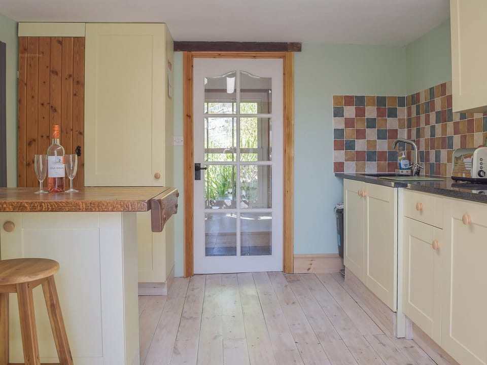 Delightful kitchen with granite tiled worktops | Woodlands, Laugharne, near Pendine