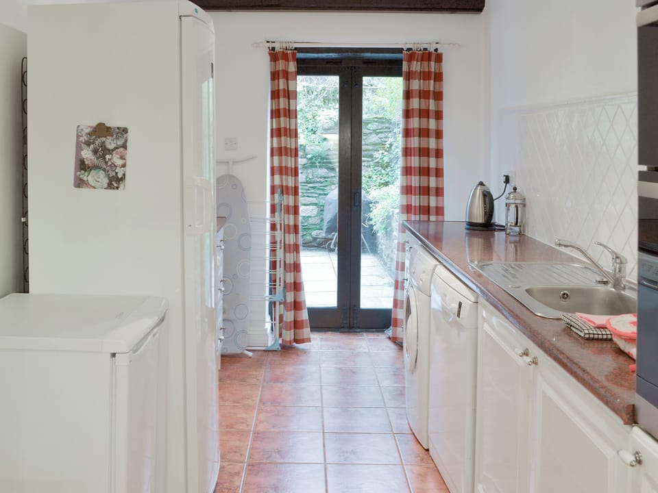 Kitchen with French doors to patio area | Dray Cottage, East Allington, near Totnes