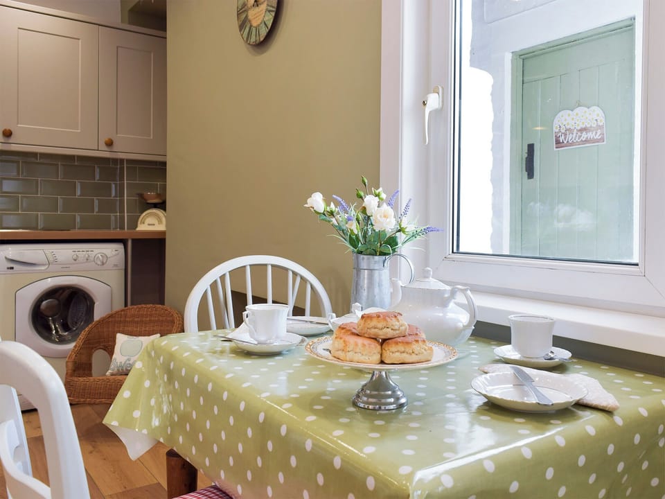 Galley style kitchen with breakfast bar | Moss Cottage, Burry Port, near Llanelli