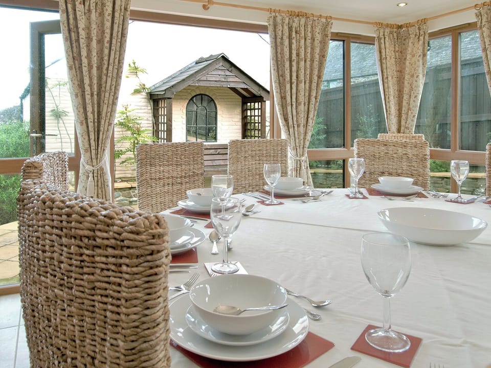 Dining area with french doors opening onto the garden | Magnolia Cottage, Aberaeron