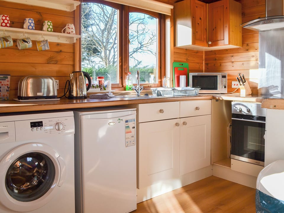Well equipped kitchen area | Ty Glan Mor (The Beach House) - Water&rsquo;s Edge Cottages, Llanfaes, Beaumaris, Anglesey