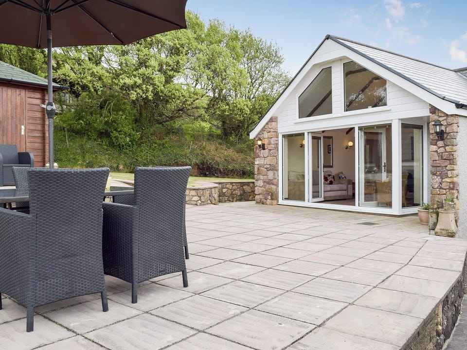 Patio area with seating | Brynymor Cottage, Llangennith, near Swansea