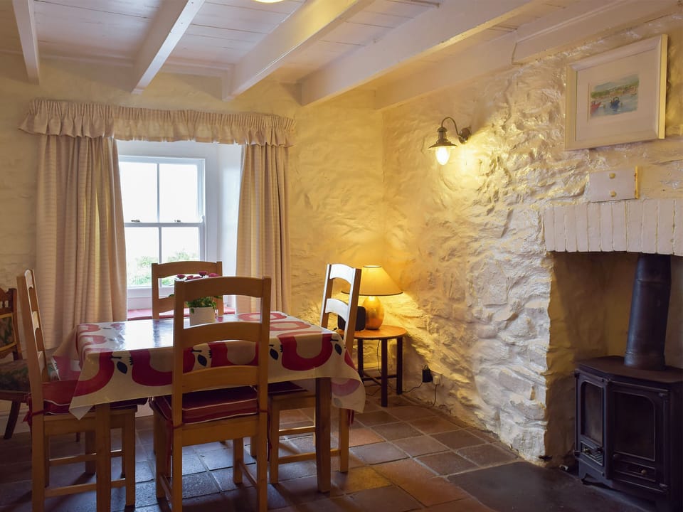 Dining room with wood burner | Preswylfa, Trefin, near St Davids