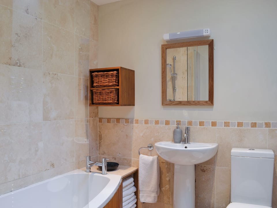 Bathroom with shower over the bath | Riccal Heads - Grange Farm Cottages, Spaunton, near Lastingham