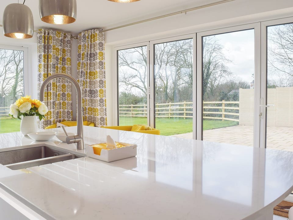 Bi-fold doors to the large patio make it ideal for alfresco entertaining | Ivy Bush Cottage, New Moat, near Narberth