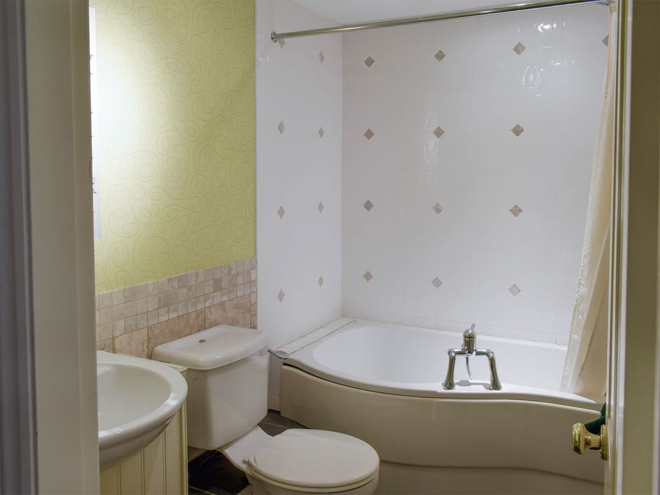 En-suite bathroom with shower above bath | York House, Hudswell, near Richmond
