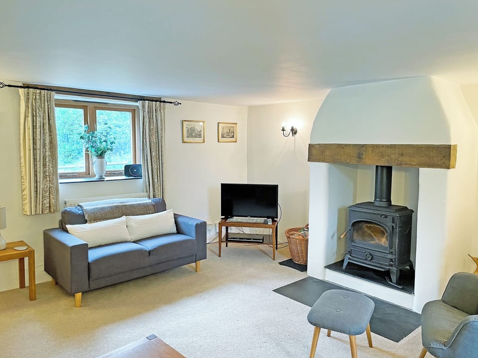 Welcoming living room with wood burner | The Shippon, St Gennys, Bude