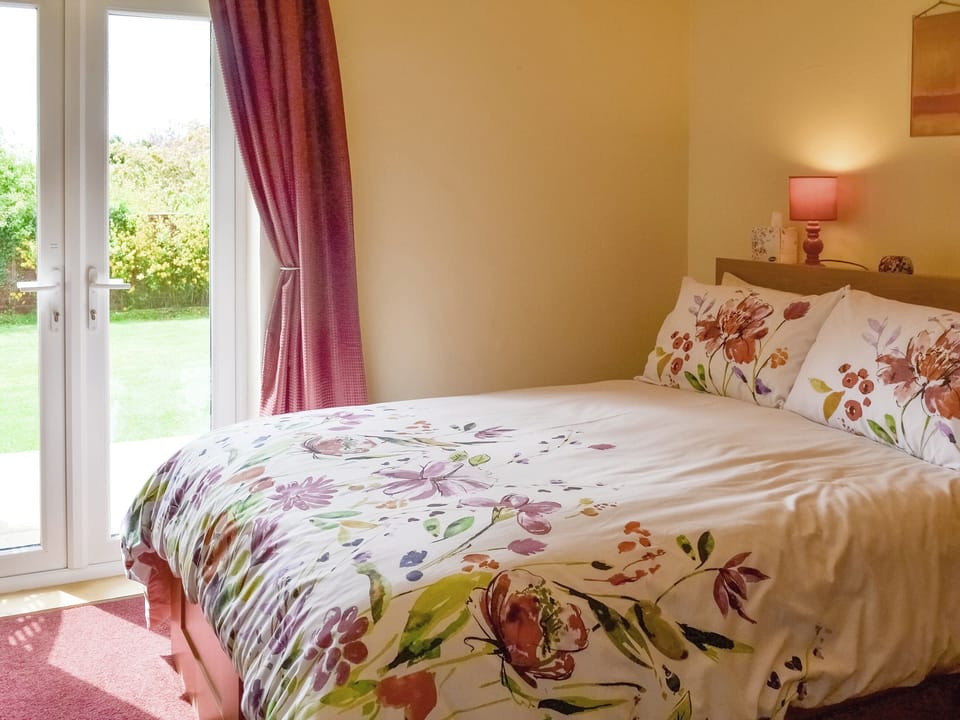 Relaxing double bedroom with French doors to garden | 1&frac34; Denwick View, Alnwick