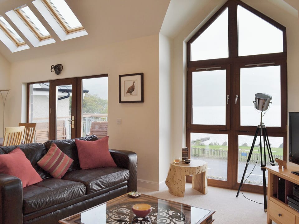 Large open plan living area with patio doors leading onto the balcony | The Quaich, Fearnan, by Aberfeldy