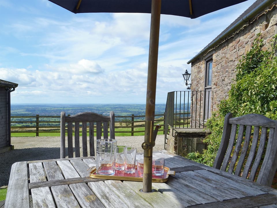 Outdoor eating area with great views over the surrounding countryside | The Old Byre, Thorncliffe, near Leek