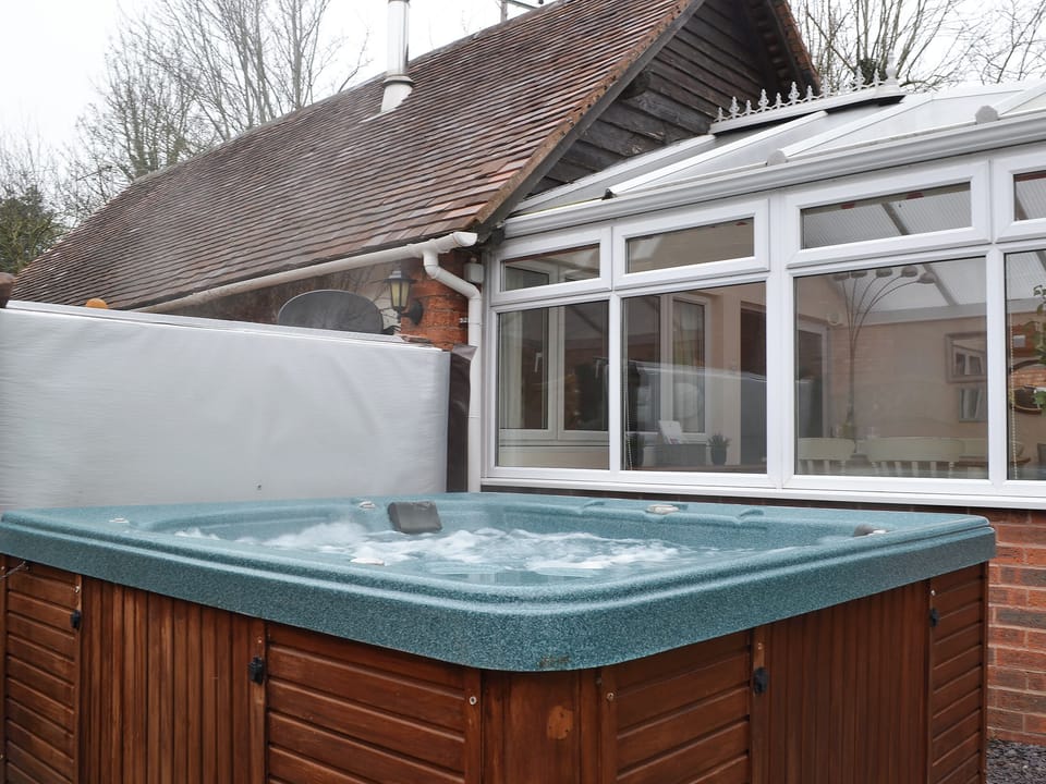 Relax in the private hot tub | The Old Winery Cottage, Newent