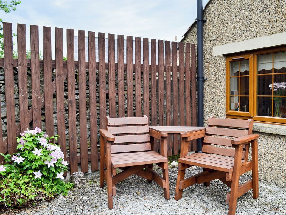 Small courtyard with sitting-out area and garden furniture | Swallowtail Cottage - Studley House Farm Cottages, Ebberston, near Scarborough