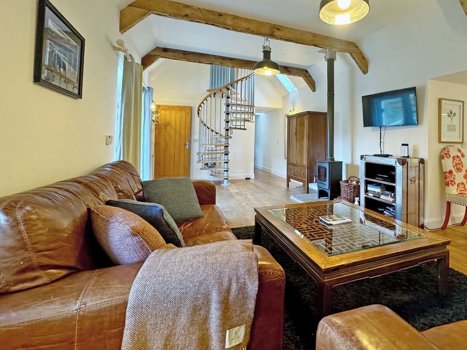 A spiral staircase allows for mezzanine access to extra space for a quiet read or relax, overlooking the harbour | The Byre - Rispond Estate, Rispond, near Durness
