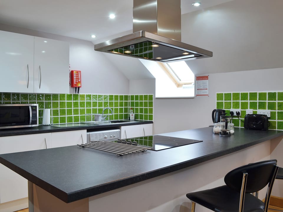 Lovely tiled splashbacks and clean modern fittings in the kitchen area | The Loft - Lluest Cottages, Neuaddlwyd, near Aberaeron