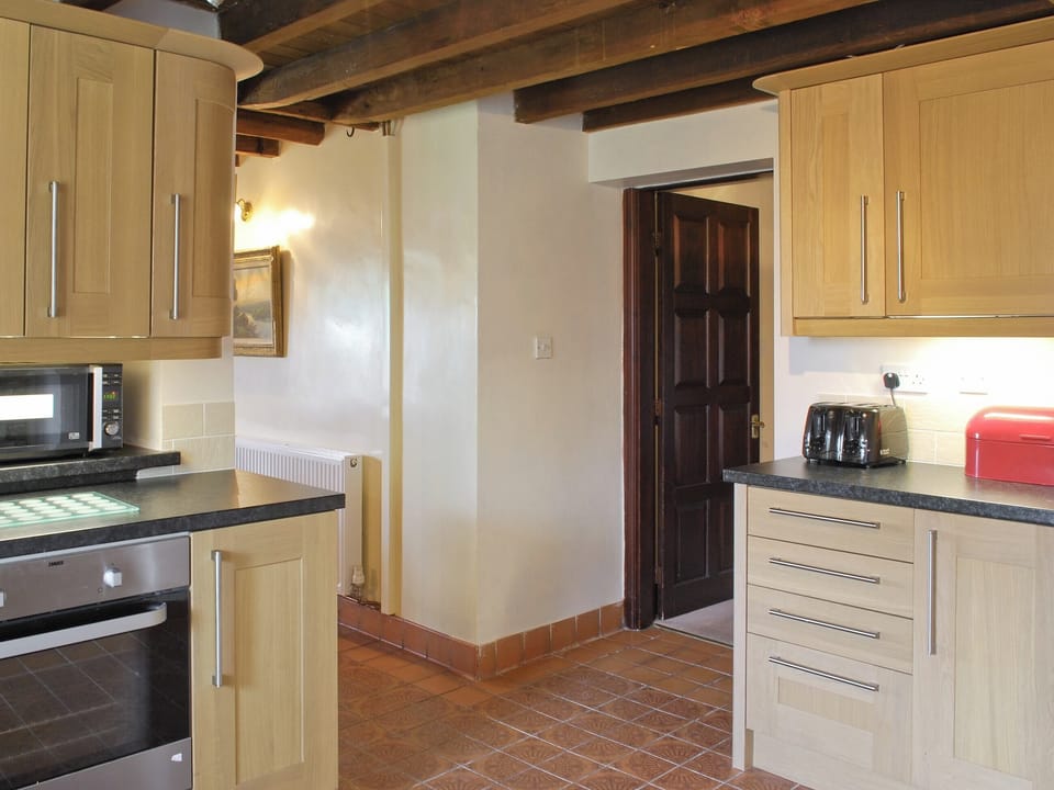 Tile-floored kitchen accessed from the dining room | Broadmeadows Farm, Butterton