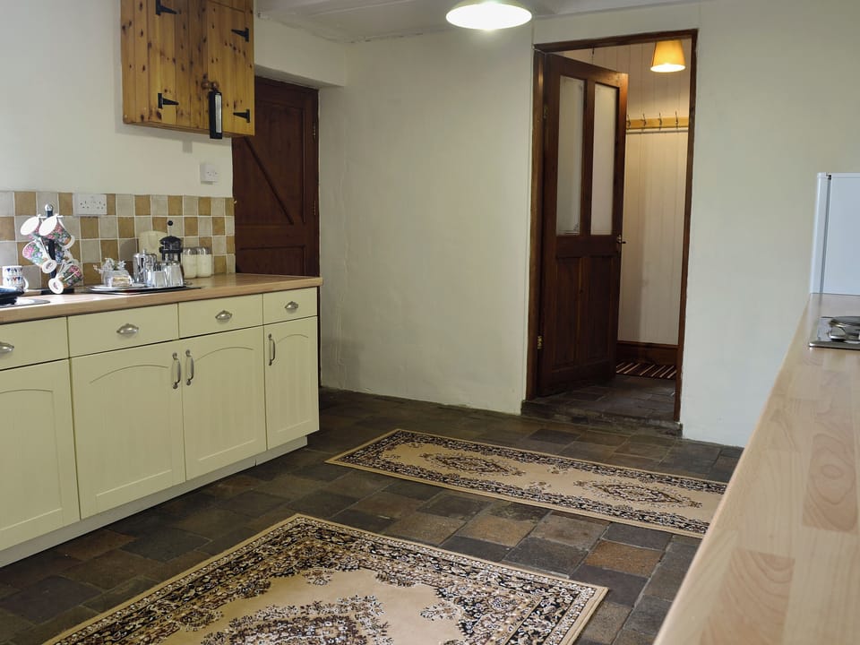 Farmhouse style kitchen with breakfast area | Bettws y Gwynt, Llanbedrgoch, near Benllech