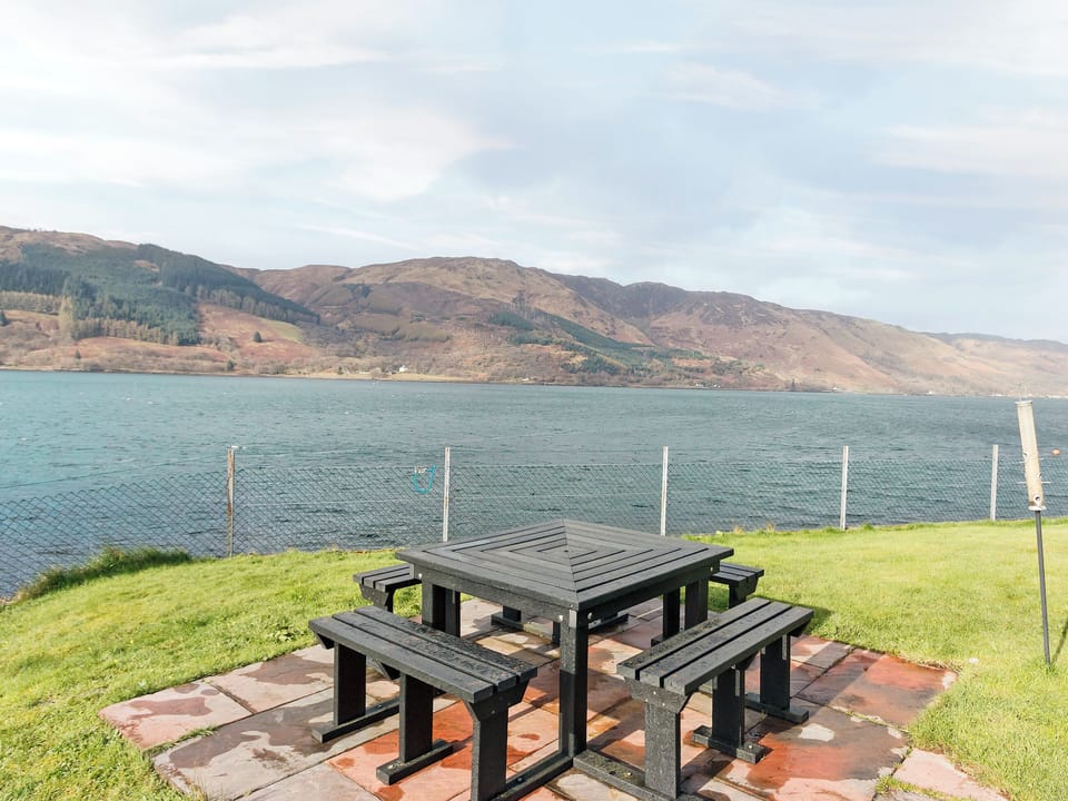 Sitting-out-area set right on the shore | Loch Duich Cottage, Inverinate, by Kyle