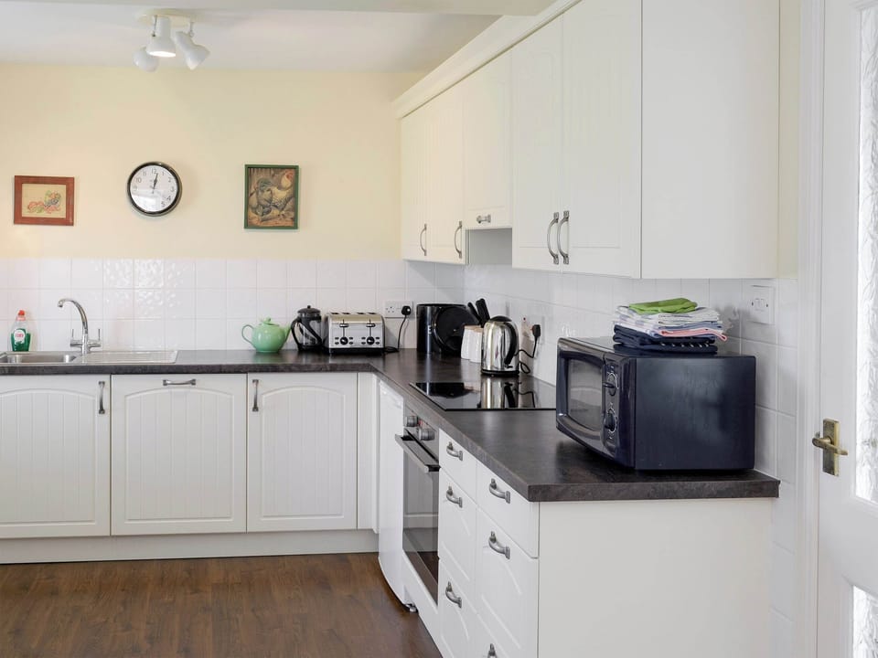 Well-equipped fitted kitchen | Rowan Cottage - Glenrossal Cottages, Rosehall, near Lairg