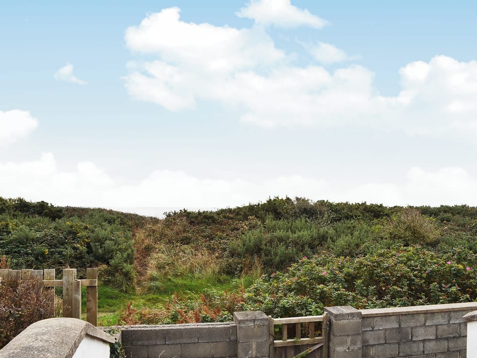 Sea view from the decked area with access to coastal path | Glan-Mor, Pwllheli