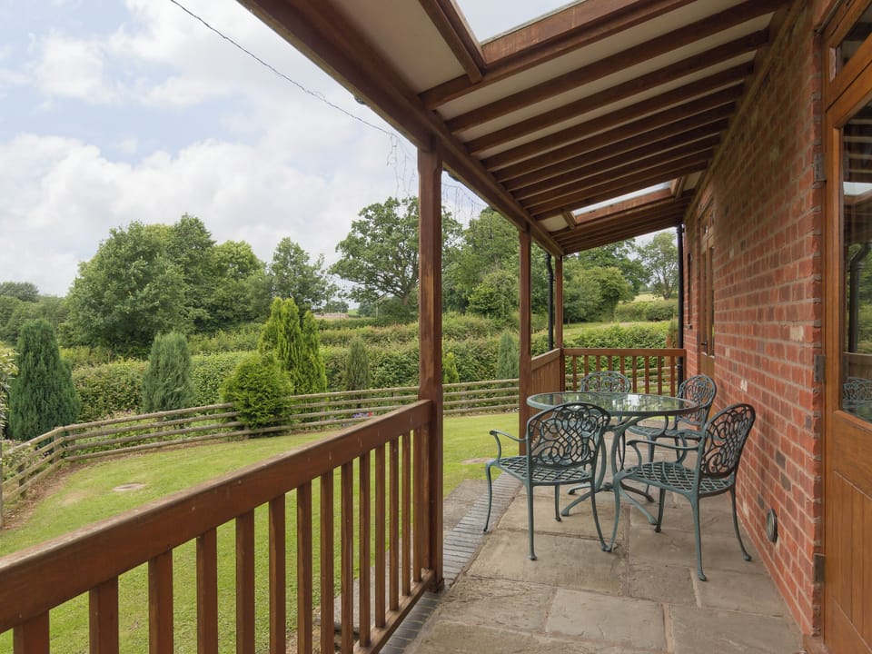 Terrace with outdoor furniture | Parkers Lodge - Netherley Hall Cottages, Mathon, near Malvern