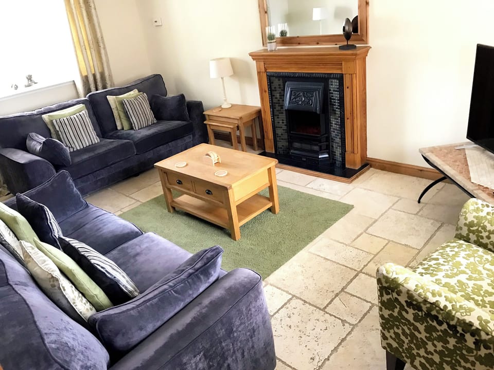 Comfortable living room with tiled floor | Brankley Cottage - Brankley Farm Cottages, Dunstall Cross, near Barton-under-Needwood