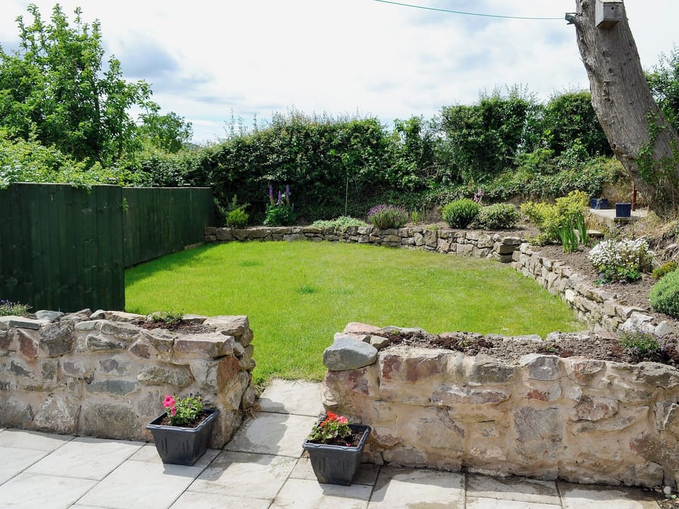  Enclosed lawned garden with patio and garden furniture | Dolfran Bach, Dolwen, near Betws-yn-Rhos, Abergele