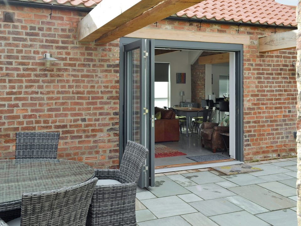 Bi-fold doors from patio to living area | Bluebell Barn, Dunnington, near York