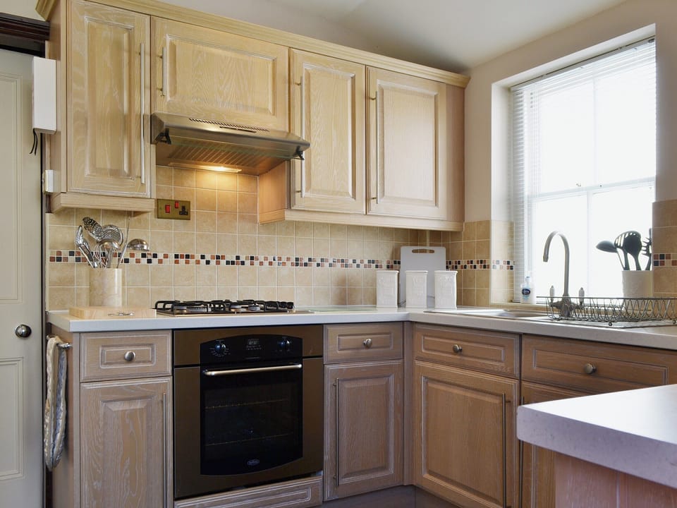 The tiled floor in the dining area extends into the well equipped kitchen | Oak Lea, Keswick