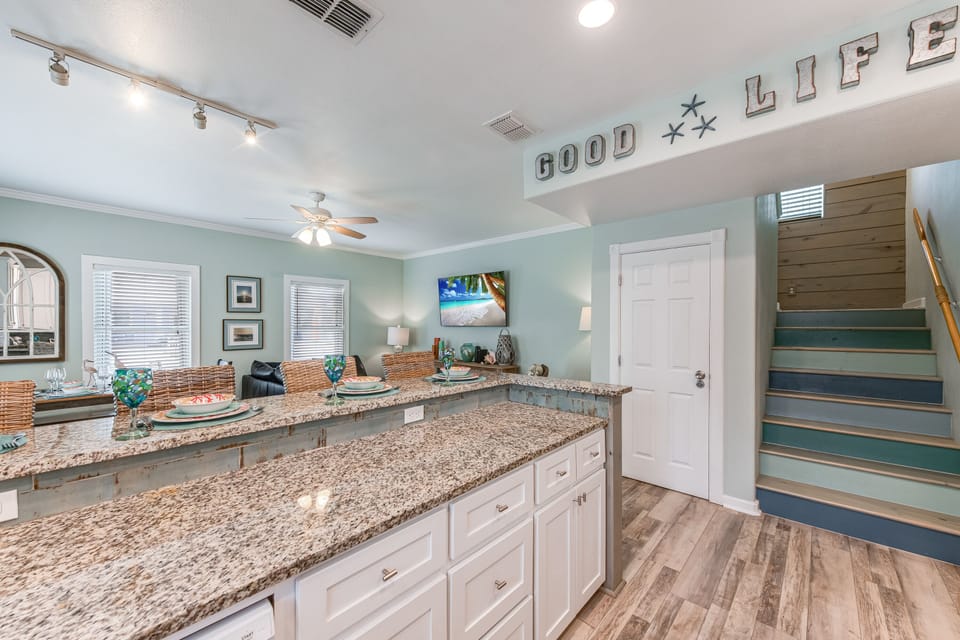 Interior - The open kitchen flows effortlessly into the cozy living area, creating the perfect space for entertaining or relaxing