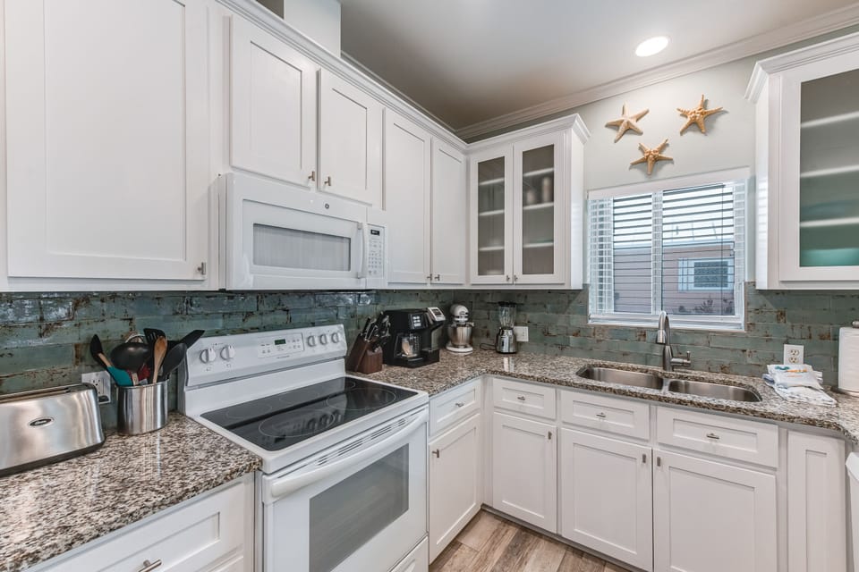Interior - A stylish kitchen anchors the home, blending function with coastal charm