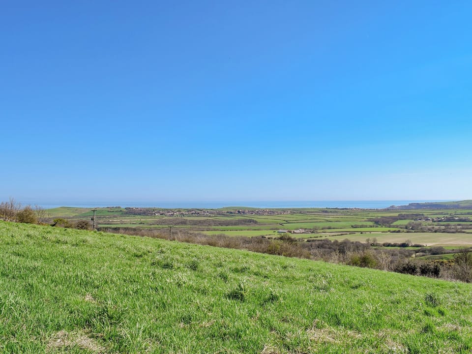 Stunning views from the bottom of the yard towards the coast, overlooking Hinderwell and Runswick Bay | Sycamore Cottage, Borrowby, near Staithes