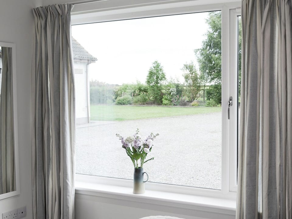 View of front garden from the bedroom | Barn Owl Cottage, Newton, near Tain