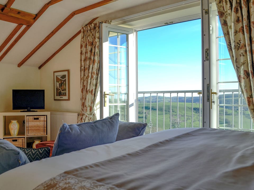 Light and airy bedroom with Juliet balcony | Meadow Croft - The Crofters Cottages, Llangeinor, near Bridgend