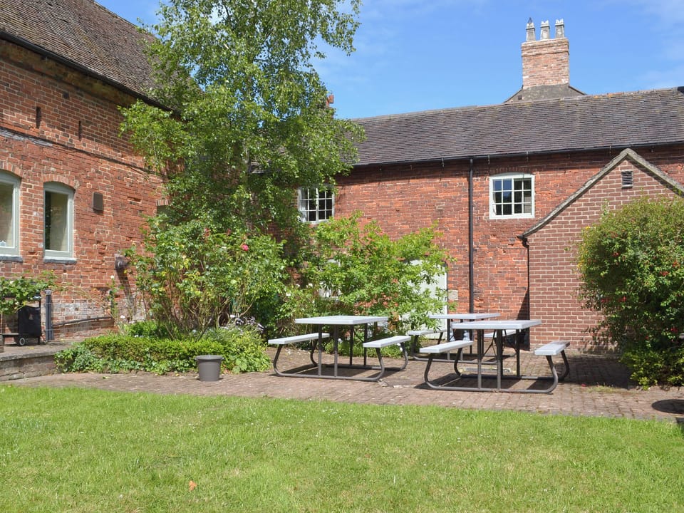 Shared patio area with outdoor seating. Ideal for a BBQ or a family gathering. | Repton Cottage, Burdett&rsquo;s Cottage, Foremark Threshing Barn - Foremark Cottages, Milton, near Repton
