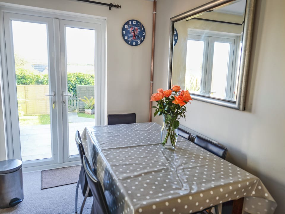 Inviting dining area with French doors leading to garden | The Yellow House, Padstow