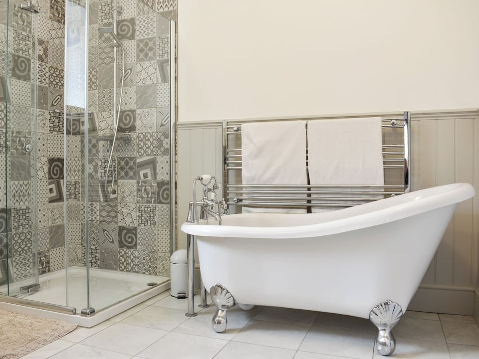 Well presented bathroom with roll top bath and separate shower cubicle | Coach House, Wareham