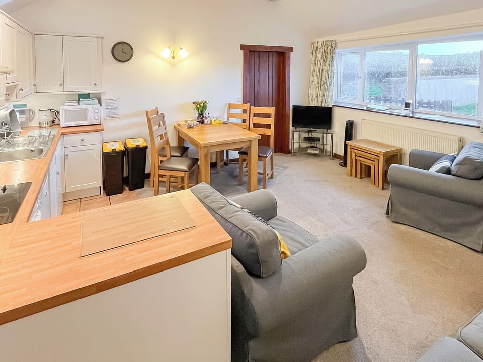 Comfy seating within the living area | Woodpecker - Manor Court Cottages, Shipton Gorge