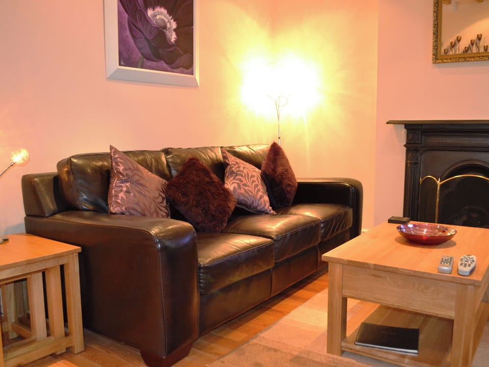 Living room with open fire | Duckling Cottage, Bowness on Windermere