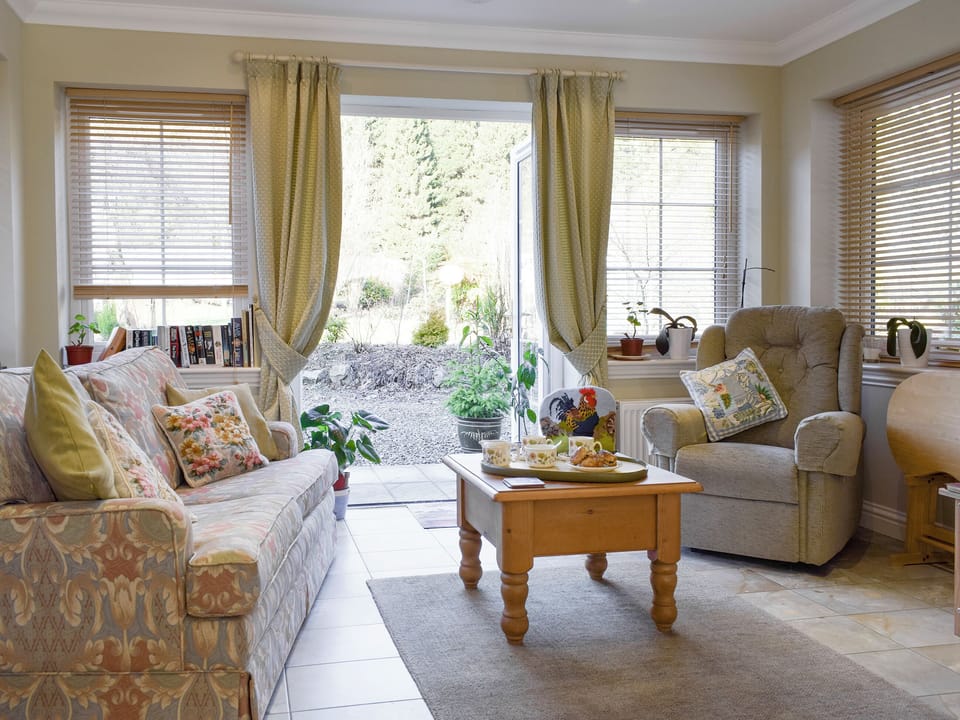 Welcoming living room with French doors to garden | The But &rsquo;n&rsquo; Ben - Hatton Cottages, Dunkeld, near Pitlochry