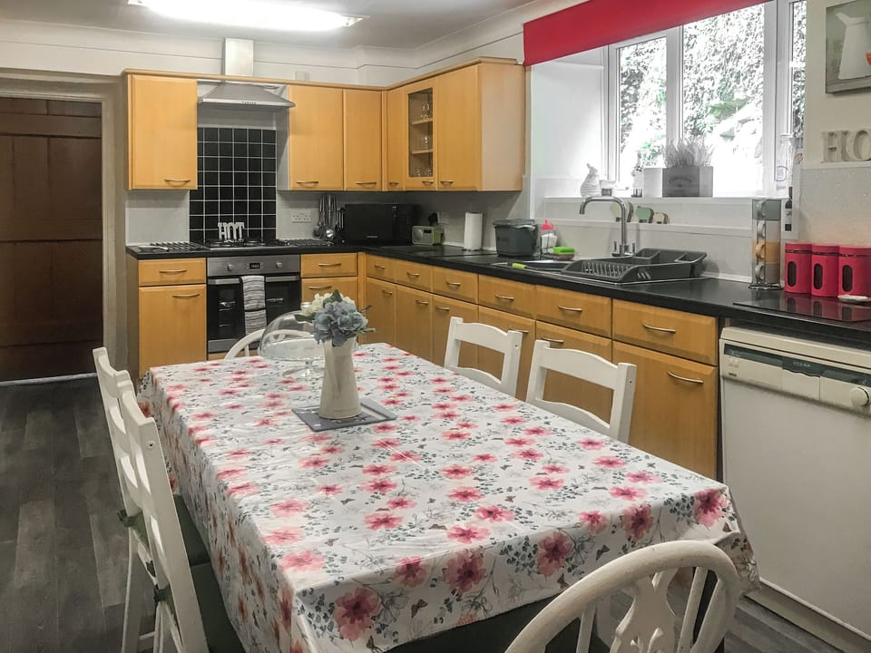 Well-equipped fitted kitchen with dining area | Bryn Euryn Cottage, Rhos-on-Sea, near Colwyn Bay