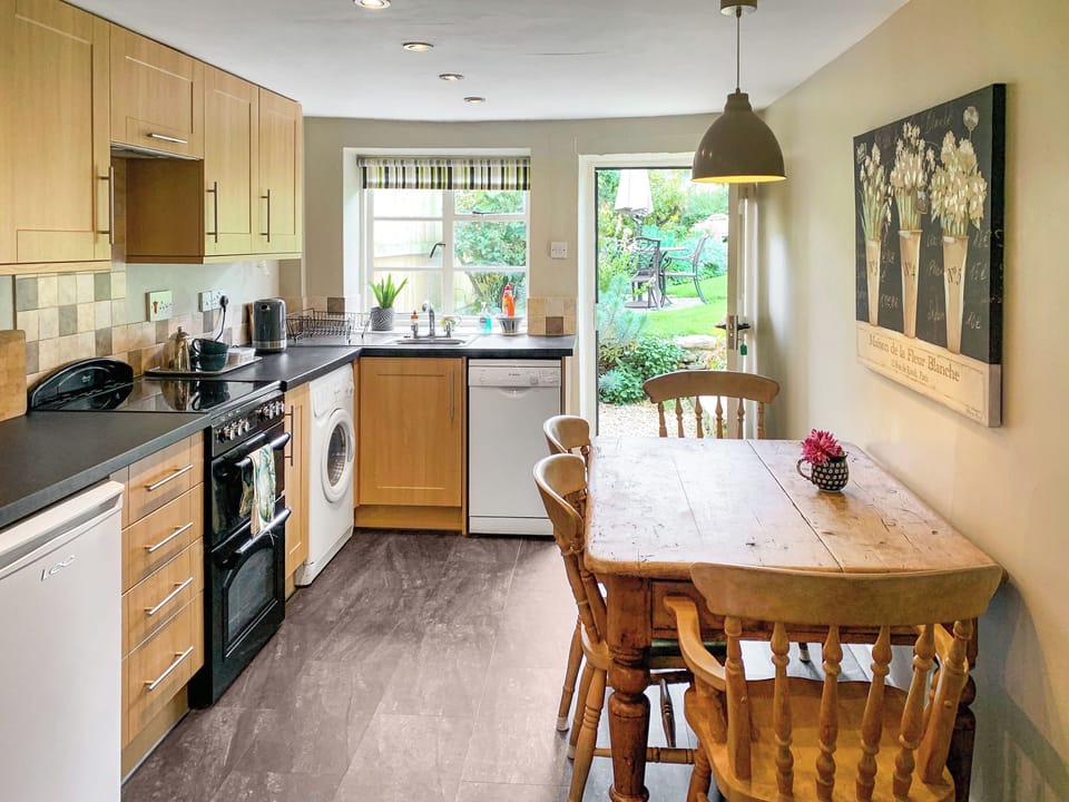 Kitchen with door leading to garden | Barters Cottage, North Chideock, near Bridport
